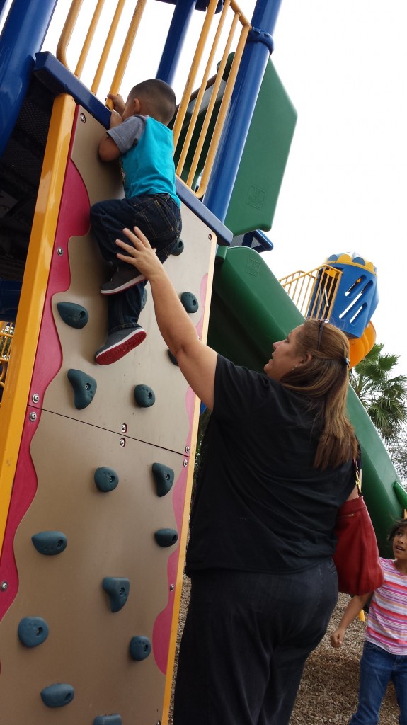Dina helping Julien rock climb