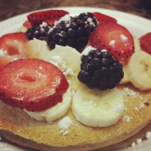Whole-wheat pancakes, fruit and a dusting of powdered sugar.